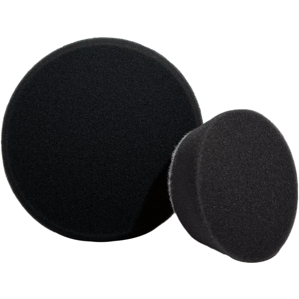 Two black polishing pads on a white background
